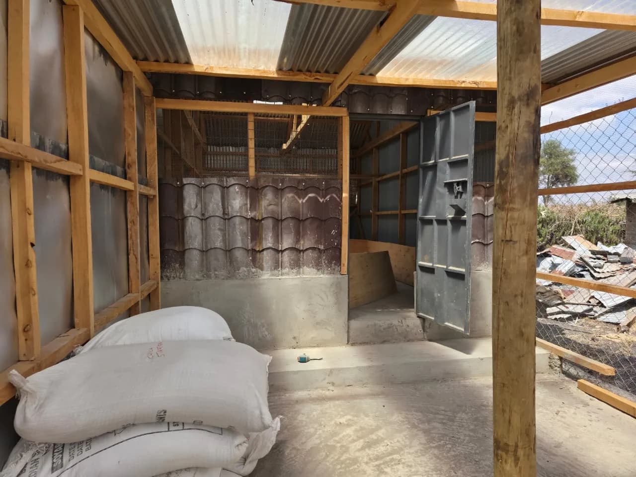 Feed sacks stored beside the poultry cage